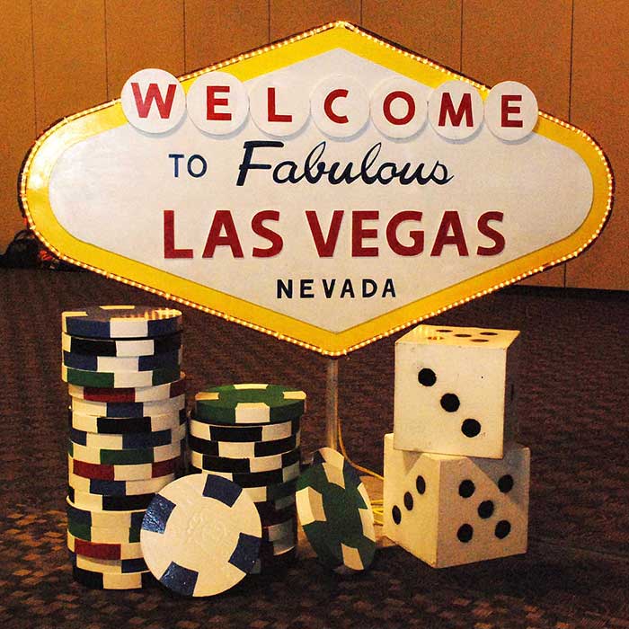 Las Vegas sign with giant poker chips and dice